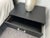 Cantoni Collection Merit two-drawer nightstand in black leather with matching stitching, brushed stainless steel pulls and...