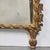 Hand-carved and gilded, framed mirror featuring a Neo-classical figure in a medallion on top, flanked by a pair of phoenix...