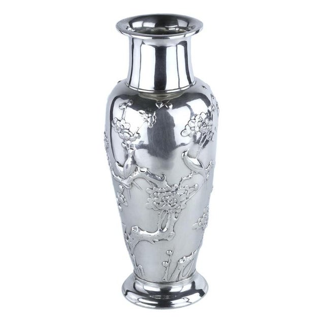 An exquisite sterling silver vase in japanese style, created by the renowned american firm tiffany & co. The surface is...