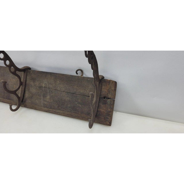 This vintage wood and cast wall hanging coat hat rack features 6 hooks and serves as a rustic western cabin lodge...