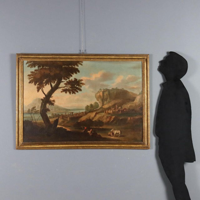 Oil on canvas. 18th-century Italian school. The landscape features a verdant countryside with rolling hills and a village...