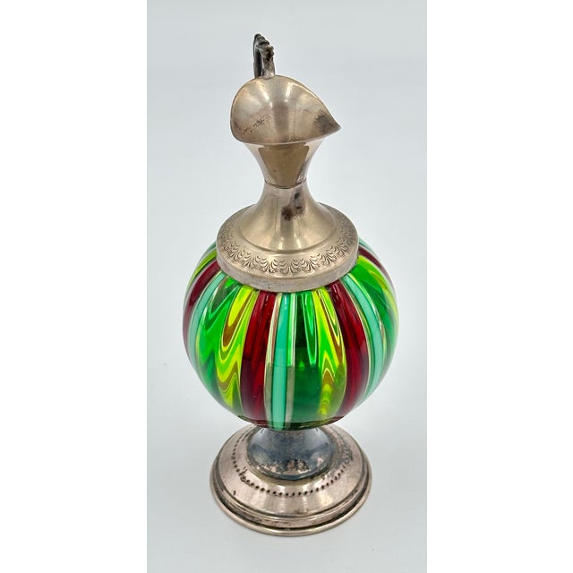 Discover the exquisite charm of this genuine Italian Handblown Murano Art Glass Mini Pitcher, a true treasure for any...