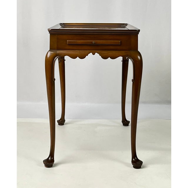 A beautiful Queen Anne style tea table crafted in solid mahogany by Kittinger, featured as part of the official Colonial...