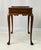 A beautiful Queen Anne style tea table crafted in solid mahogany by Kittinger, featured as part of the official Colonial...