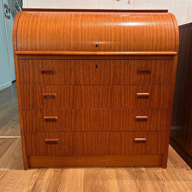 Elegant Danish secretary desk crafted in teak, featuring a roll-top design with a sleek, streamlined silhouette. Lockable...