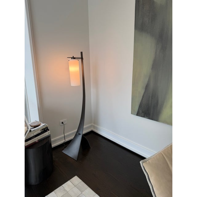 A striking Hubbardton Forge floor lamp showcasing the brand’s signature blend of sculptural metalwork and warm,...