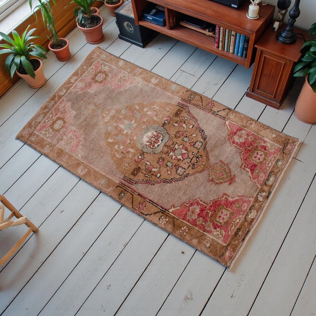 Welcome to our curated collection of authentic Anatolian textiles. This exquisite petite rug embodies the timeless charm...