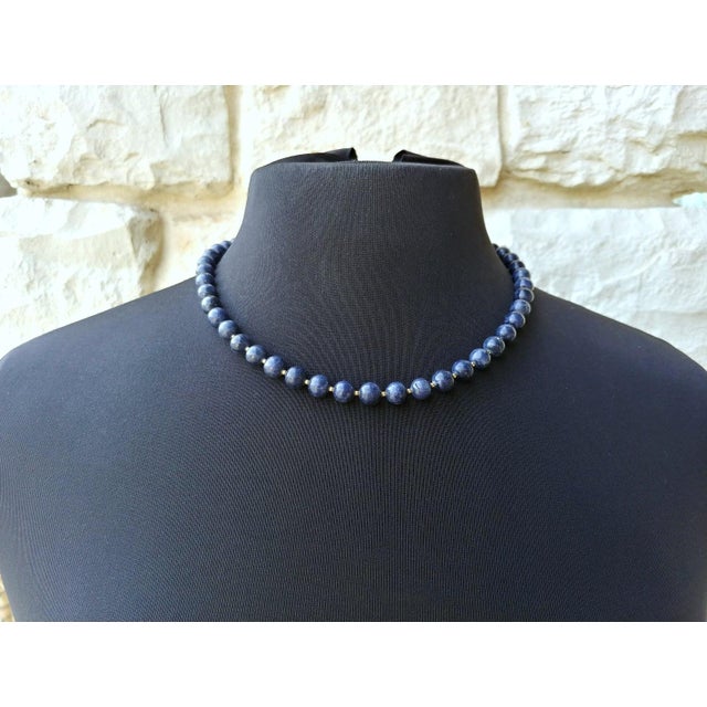 Necklace featuring natural blue sapphire beads from Myanmar. The beads are an opaque, dark blueberry color with a matte...