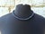 Necklace featuring natural blue sapphire beads from Myanmar. The beads are an opaque, dark blueberry color with a matte...