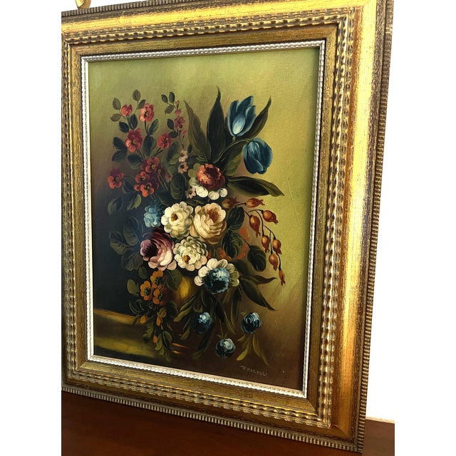 A decorative floral still life oil painting, signed fracassi, featuring a lush and colorful bouquet of roses, tulips and...