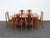 This Set of Dining Table and Six Chairs is made of wood, walnut, veneer, and upholstery. We believe it was made by Young...