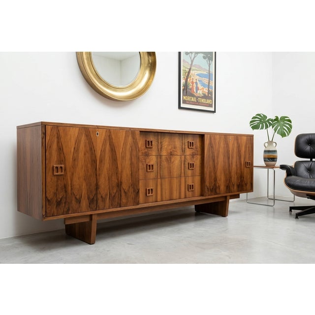 An exceptional and rare example of 1960s Hungarian mid-century design. This stunning credenza features a sophisticated,...