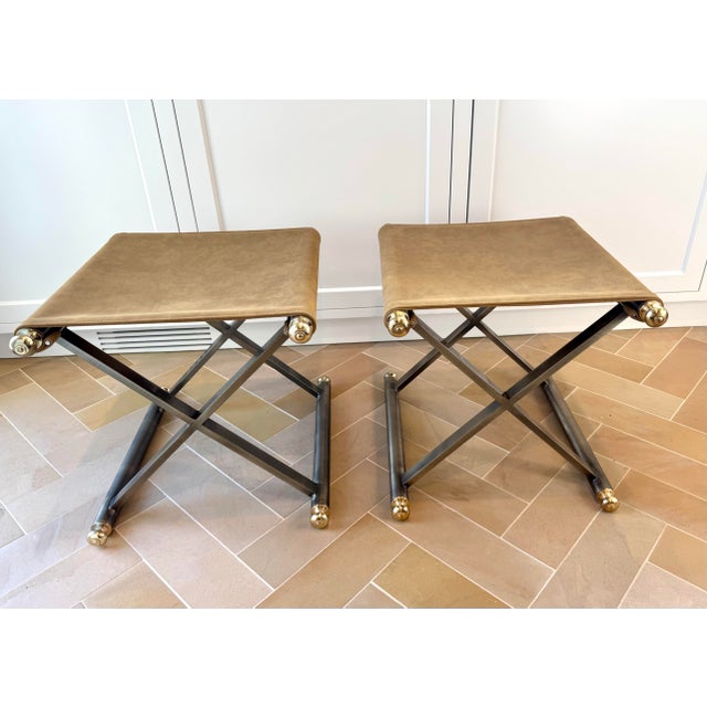 A near-pristine vintage pair of Maison Jansen style X-frame stools featuring rich camel nubuck leather sling seats,...