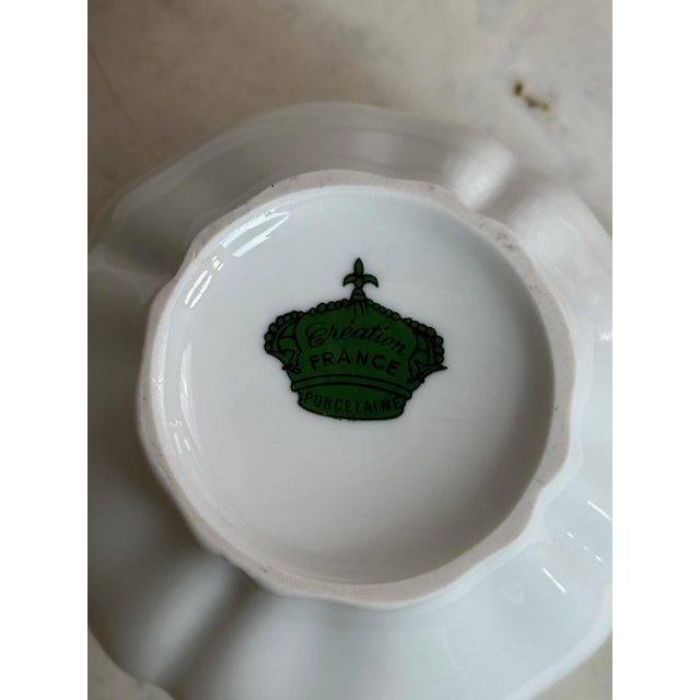 A white porcelain coffee or tea service, each piece stamped with a crown and the inscription "Création France Porcelaine"...