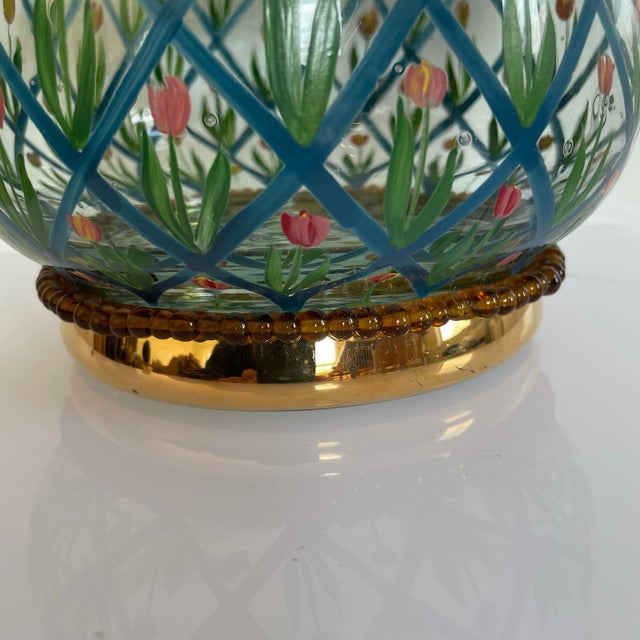 A vintage bowl by Mackenzie Childs. The hand blown and hand painted bowl features a whimsical tulip design with a diamond...