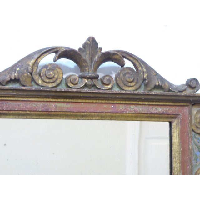 This antique Florentine carved and painted frame has a lightly distressed mirror.
