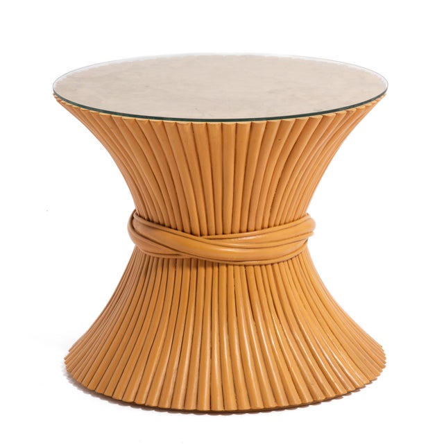 A vintage Mcguire sheaf of wheat hourglass side table with a custom glass top.
