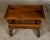 An English Georgian period walnut barley twist side table from the early 19th century with single drawer and H-Form cross...