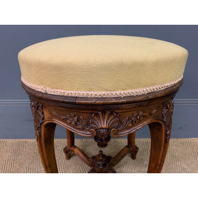 A charming 19th century French walnut piano stool. with a rotating top making it adjustable in height. with a lovely frame...