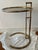 After Eileen Gray's E 1027 adjustable round chrome and glass side table This one in a brass finish with tinted glass....
