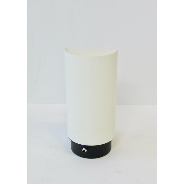 White lacquer cylinder form with pie slice opening on backside. Design by Gerald Thurston for Lightolier. Lamp appears to...