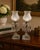 This elegant, fully matching pair of early 20th-century electrified manual luster boudoir accent lamps brings a refined...