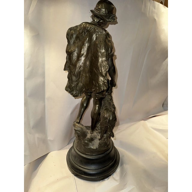 This listing is for a French Art Nouveau sculpture depicting a boy with a dog. It is made from plaster and is signed “F....
