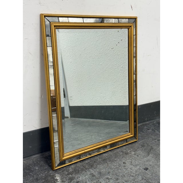 Design Plus Gallery presents a Fine Wall Mirror with Golden Frame + Mirrored Tile Trim. The double edged frame of gold...