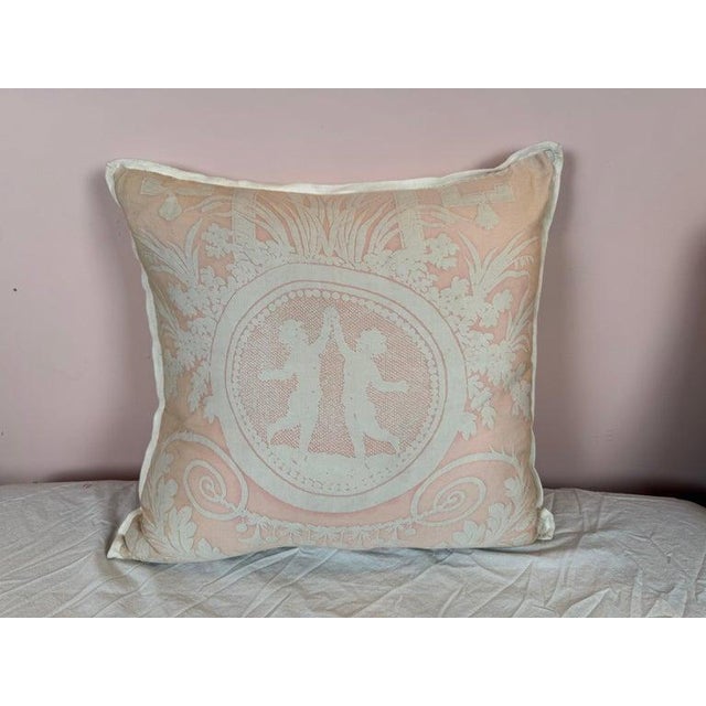 This elegant pillow showcases exquisite Fortuny textile craftsmanship. The front features a soft blush-toned background...