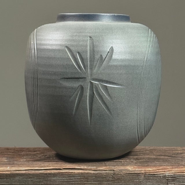 This vintage Japanese vase features a minimalist design with etched geometric decoration. Two sides display a dimensional...