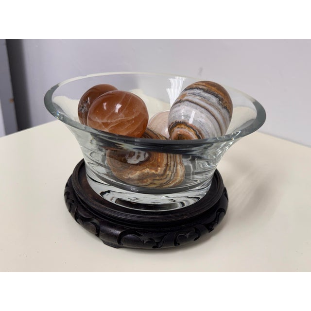 Design Plus Gallery presents a Glass Bowl + Stone Sphere Set. The flared glass bowl rests on a carved ebonized wood stand...