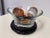 Design Plus Gallery presents a Glass Bowl + Stone Sphere Set. The flared glass bowl rests on a carved ebonized wood stand...