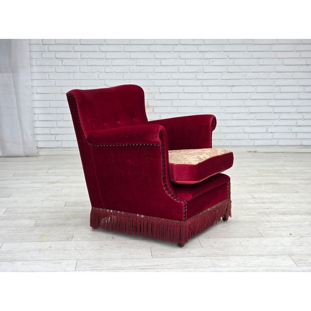 1970s, Danish armchair. Original red furniture velour, ash wood legs, brass springs in the seat cushion. Double sided seat...