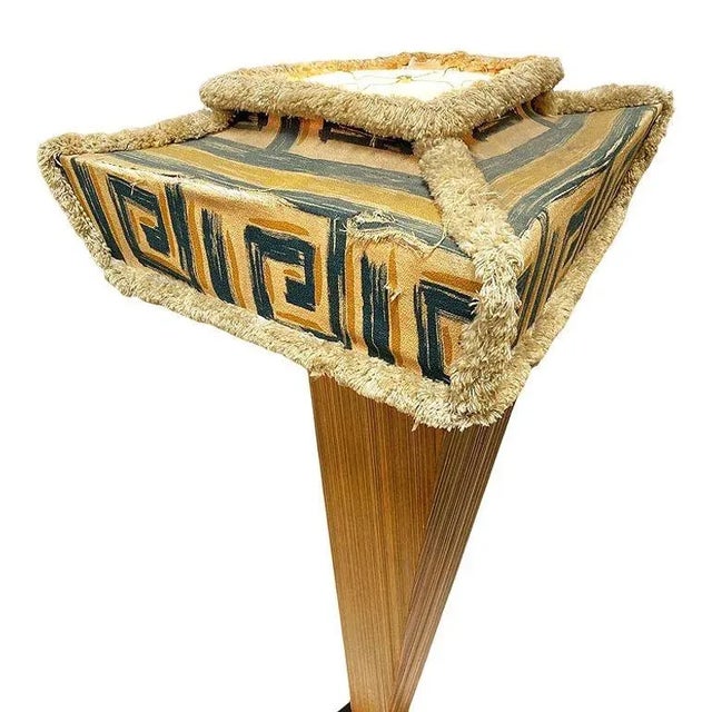 This angular Mid-century floor lamp features a combed wood body and was designed in the style of Paul Frankl. It has a...