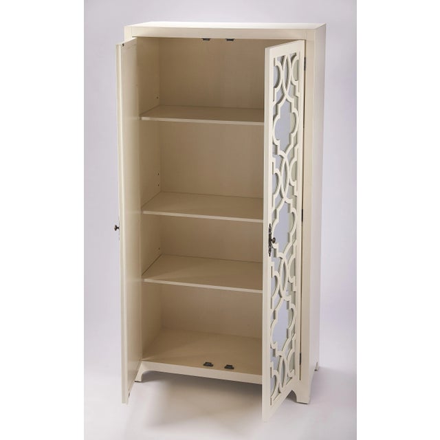 Versatile style abounds with this clean-lined tall storage cabinet. Two top doors are adornned with glass fronts, which...