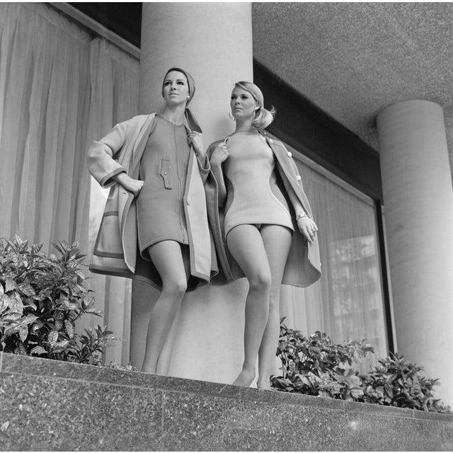 Daywear And Beachwear Two models wearing a mini dress with a zip up the front and a coat, and a swimming costume, 3rd May...