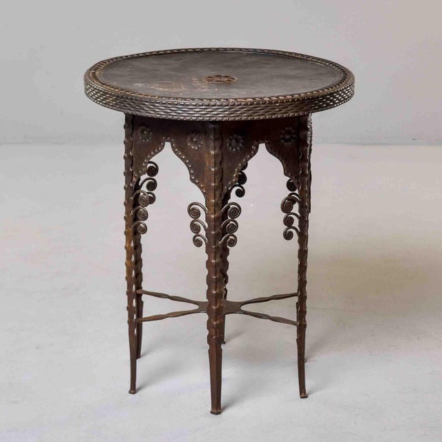 This early 20th century French garden or side table is made of iron and metal with a black finish. This table is meant for...