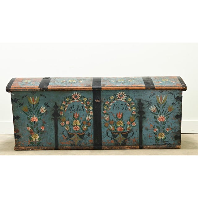 Dimensions: 25” H x 61 ⅛” W x 25 ⅛” D A large 19th century iron bound painted marriage trunk. The exterior of this truck...