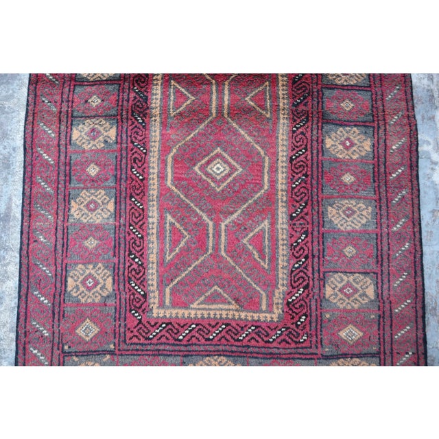 This Belouch Hand knotted wool rug with its Geometric pattern is a beautiful addition to any home. The Afghan rug is...