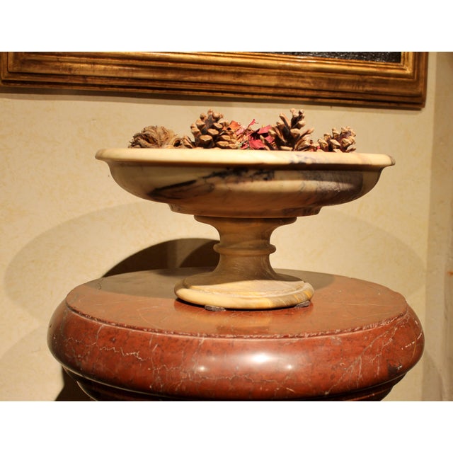 This Italian 19th century ( 1810- 1860 circa) antique neoclassical marble tazza or bowl on pedestal features round lines...