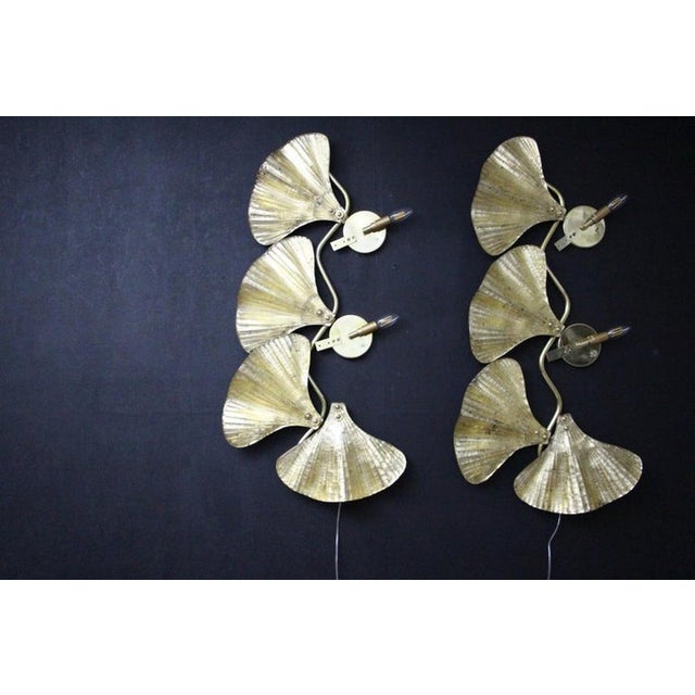 This spectacular pair of long wall lights was entirely handcrafted in Murano. Each single leaf was individually made in...