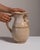 This 1960s jar from Germany is finished in antique white, worked in ceramic. Its signed detailing gives the piece a...