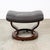 Attributed to Ekornes brown leather / cognac leather swivel ottoman. Piece is stamped beneath. Swivels as intended. Unmarked.