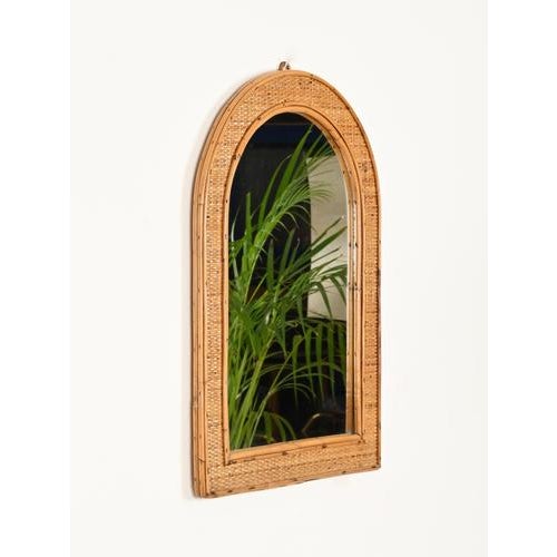 Stunning French Riviera–style arch-shaped mirror in bamboo and woven wicker. This delightful organic mirror was produced...