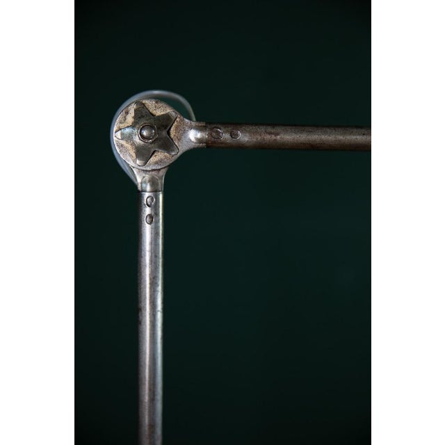 This vintage table lamp from the French brand Mazda is made of polished metal with a heavy, saucer-shaped base. The...