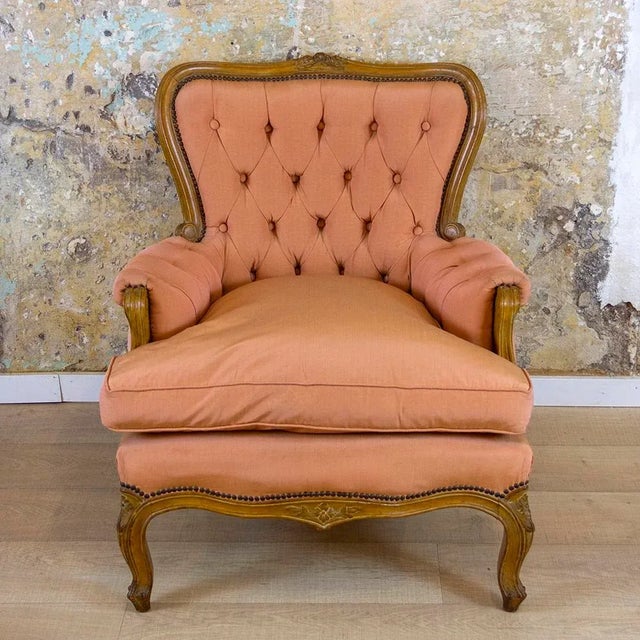Elizabethan or Neoclassical-style armchair made of walnut wood and quilted upholstery. The upholstery is original, with a...