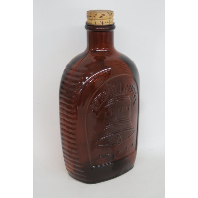 This gorgeous Log Cabin glass syrup bottle features a lovely amber color and various embossed designs around the piece. It...