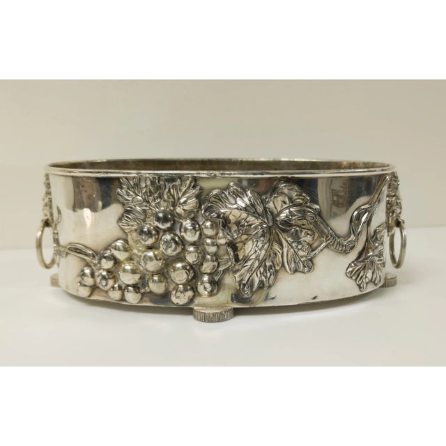 We are selling this decorative Silverplate planter or jardiniere. This oval planter has raised grape motif and figural...