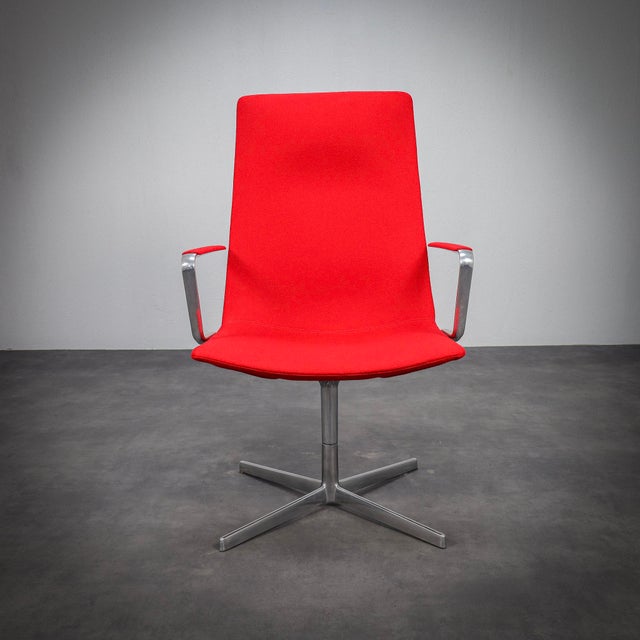 A refined pair of catifa 70 swivel lounge chairs by arper, combining elegant italian design with exceptional comfort. The...