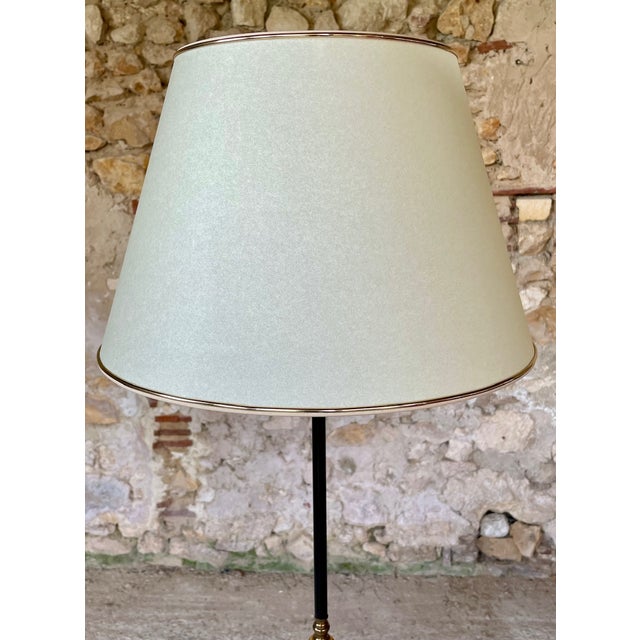 Beautiful, french, vintage floor lamp resting on tripod feet with gilded brass decor, from the 1960's. the lamp pole is...